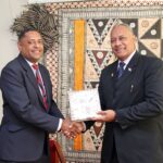 Minister for Foreign Affairs and External Trade, Hon. Sakiasi Ditoka presents a token of appreciation to the outgoing Roving Ambassador, Mr. William Toganivalu during the ceremony.